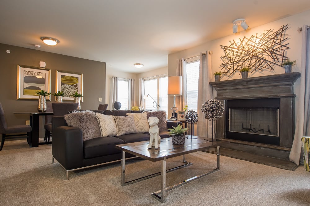 Spacious, bright living room with a fireplace at Scissortail Crossing Apartments in Broken Arrow, Oklahoma