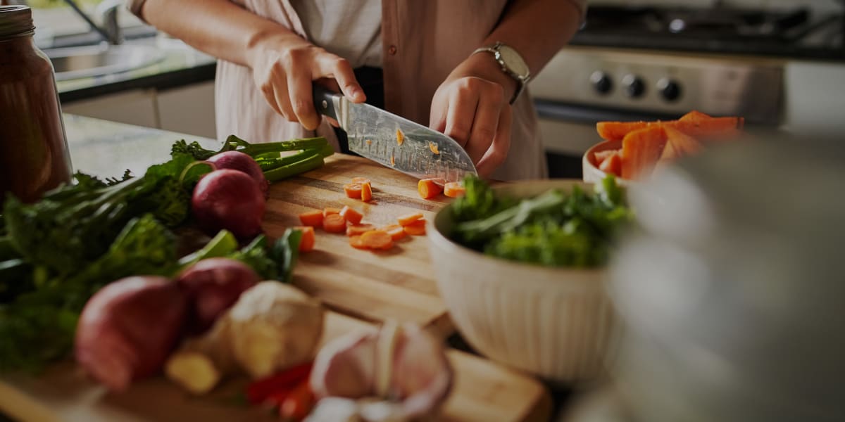 Resident cutting vegetables at Marquis at Cinco Ranch in Katy, Texas