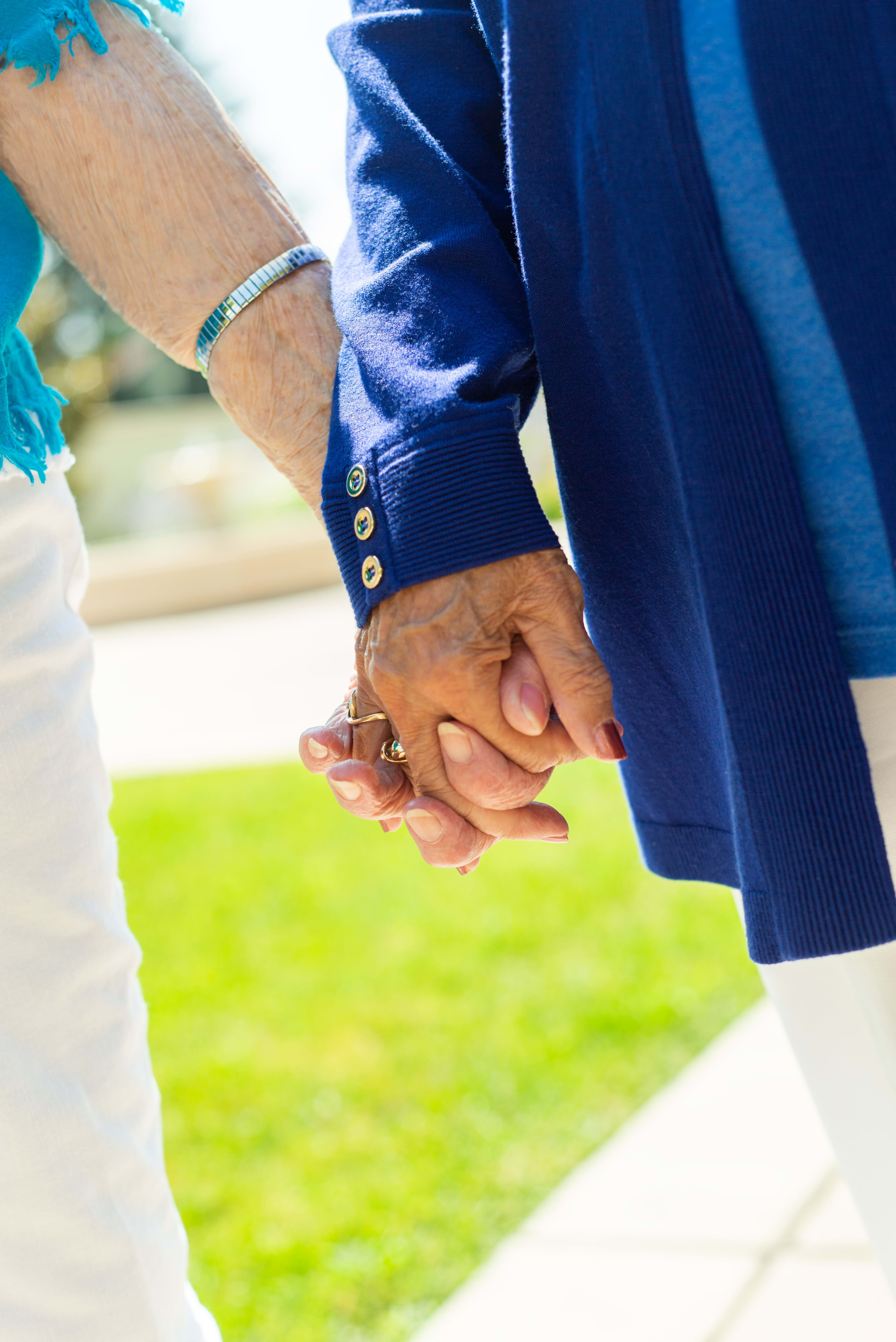 two residents holding hands at Merrill Gardens at Tukwila in Tukwila, Washington