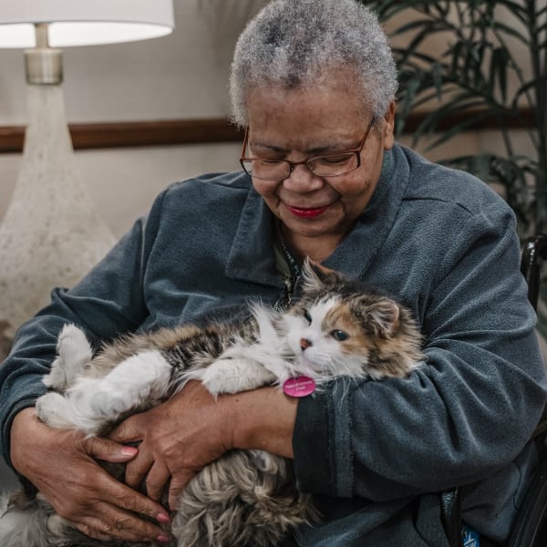 One of our active residents carrying his lovable cat at Highline Place