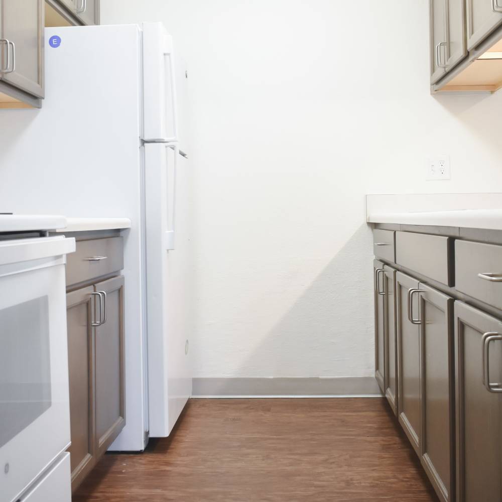 Kitchen with a refrigerator and sink at Clairewood Apartments in Saint Clair, Michigan
