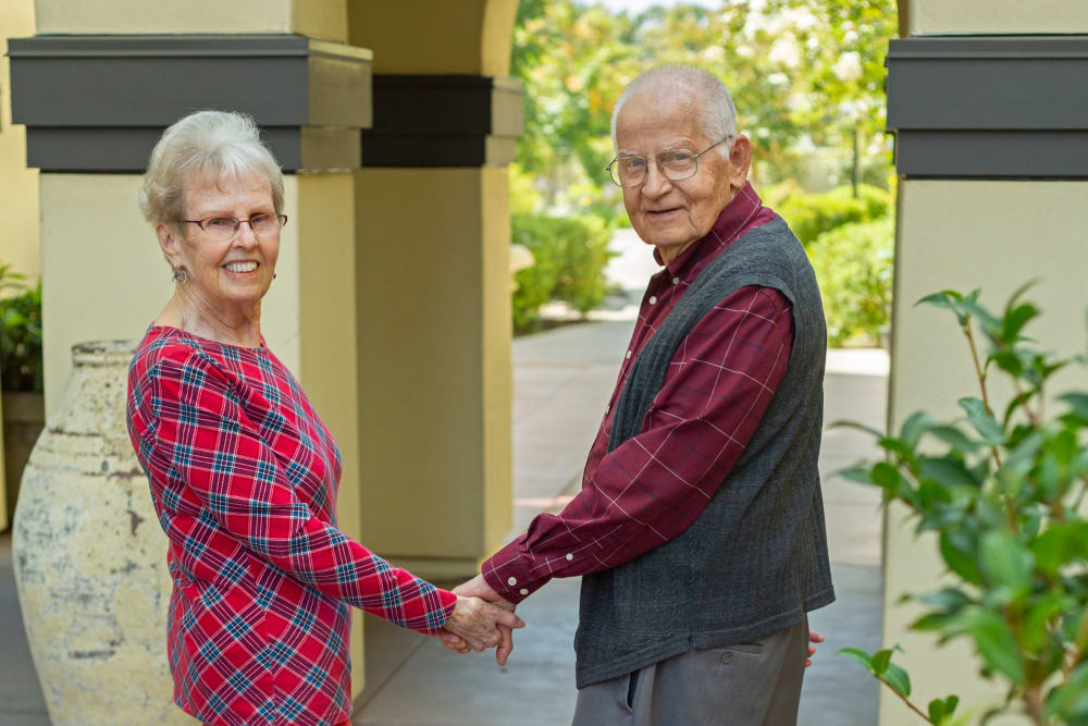 A resident couple holding hands at Merrill Gardens at Campbell in Campbell, California. 