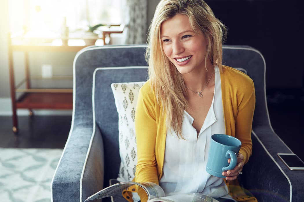Resident enjoying a cup of coffee in her apartment at Windsail Apartments in Tulsa, Oklahoma