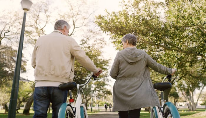 Resident couple walking outside near a Estoria Cooperatives community