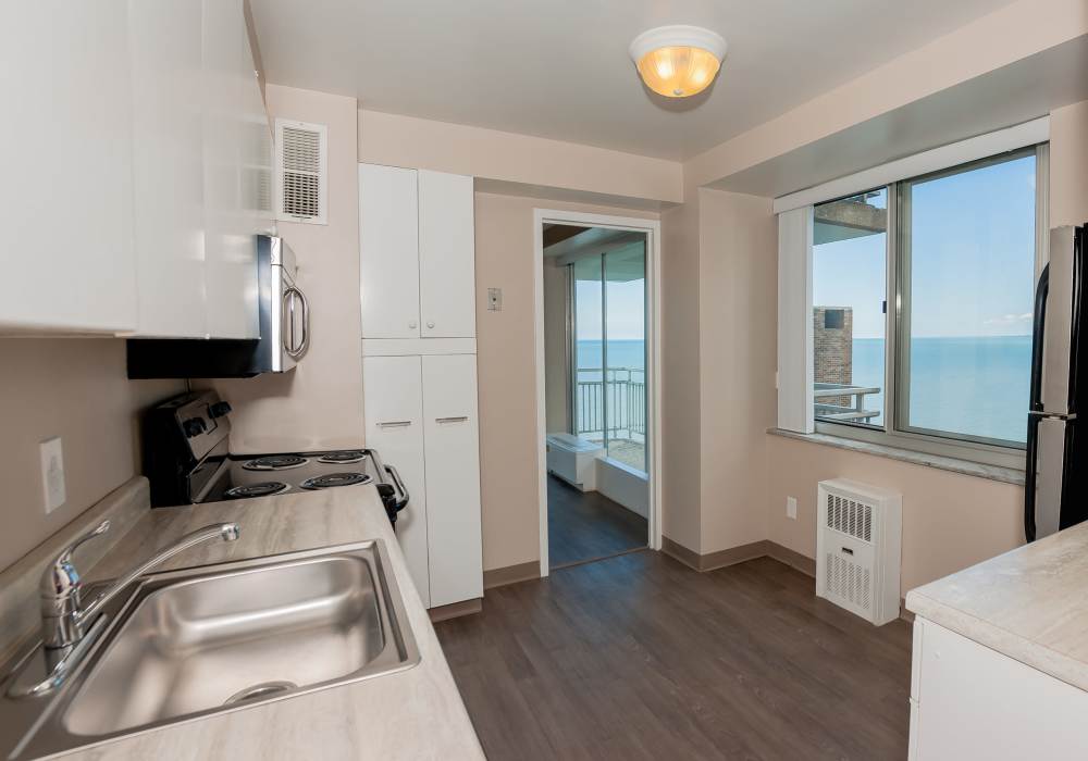 A view of the kitchen showing white colored appliances at 12000 Edgewater in Lakewood, Ohio