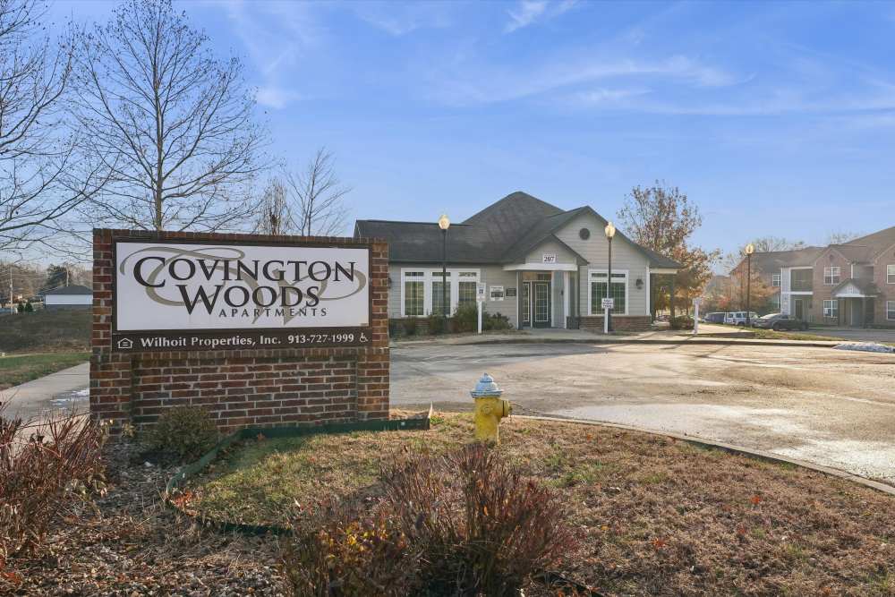 Charming entrance to Covington Woods Apartments in Olathe, Kansas, featuring inviting landscaping and a welcoming atmosphere. Covington Woods Apartments in Lansing, Kansas