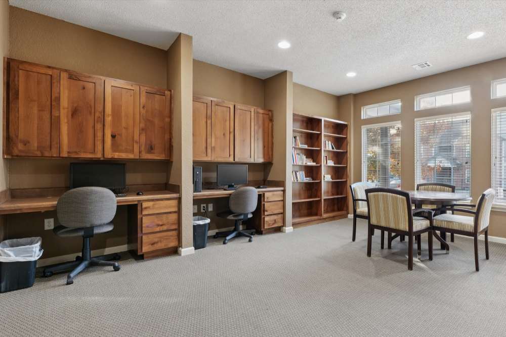 Charming office space with built-in wooden desks and cozy seating at Covington Woods Apartments in Lansing, Kansas.