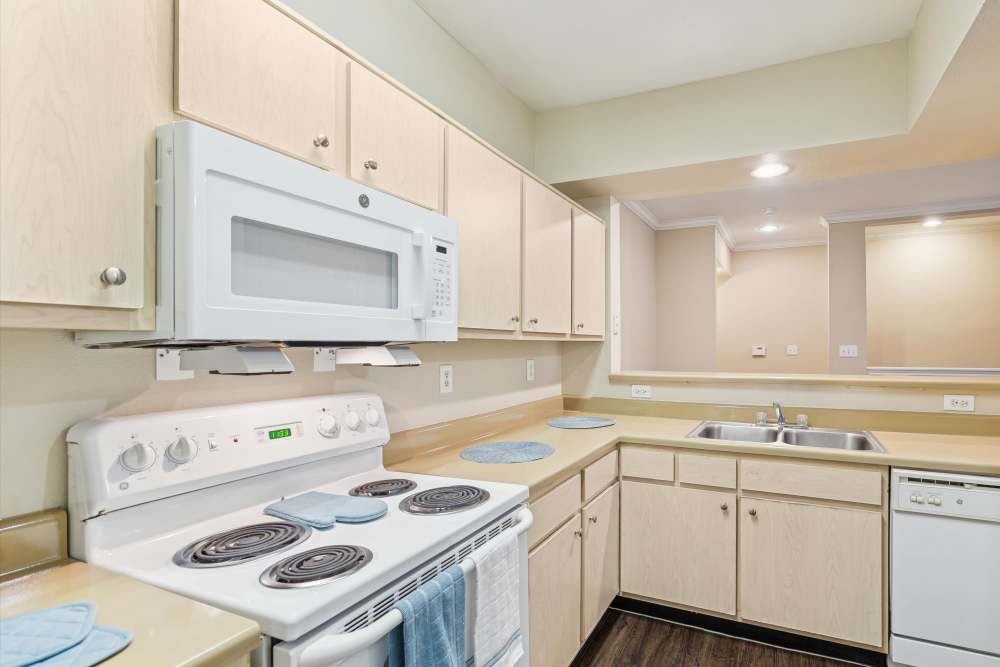 Kitchen with wooden cabinets at Mayfair Park in Houston, Texas