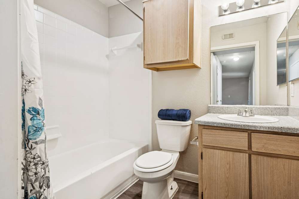 Charming bathroom with modern finishes and stylish cabinetry at Scott Street Townhomes in Houston, Texas.