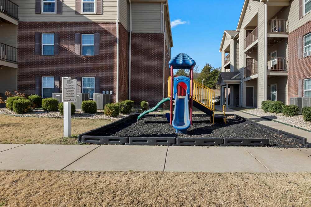 Colorful playground with slide near apartment building at Wickham Gardens in Sapulpa, Oklahoma