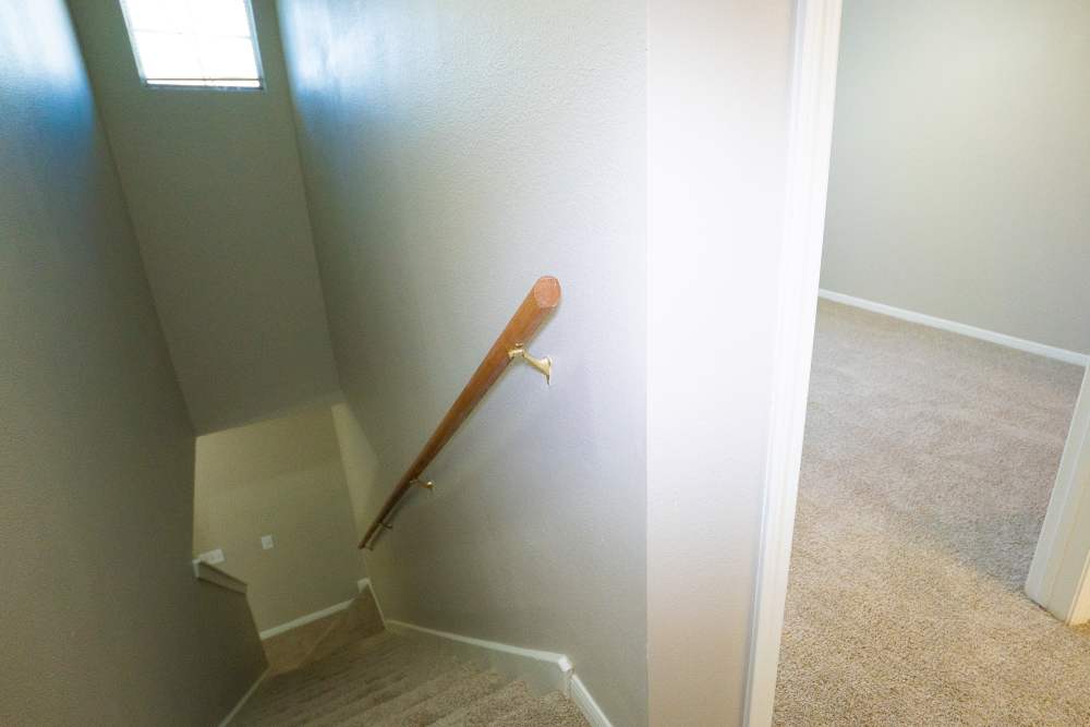 Staircase and bedroom next to staircase at Millpoint Townhomes in Henderson, Texas