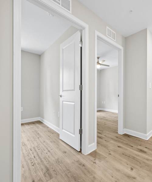 Bedroom entrance with wood-style flooring at Bluebird Commons in Statesville, North Carolina