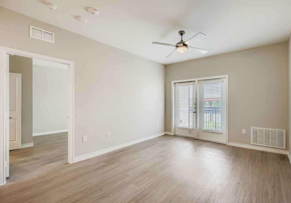 Spacious living room with natural light and sliding glass doors at Standard at Royal Lane in Dallas, Texas