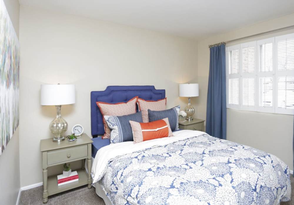 Large comfortable bed at Wasatch Club Apartments in Midvale, Utah,