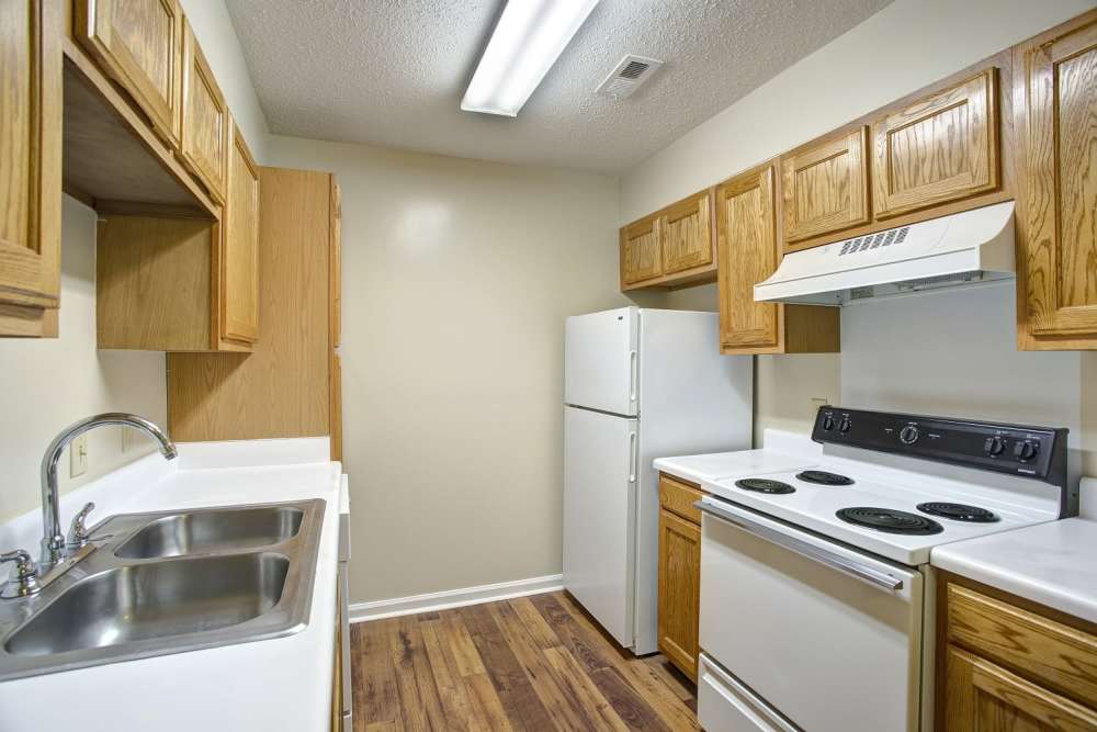 Kitchen with dishwasher and wooden flooring at Ridgewood at Greenbrier in Greenbrier, Tennessee