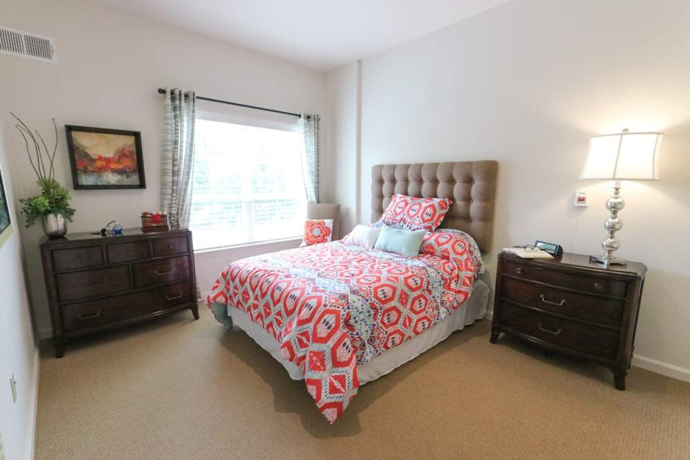 Bedroom with comfortable bed and large windows at Harmony on the Peninsula in Yorktown, Virginia