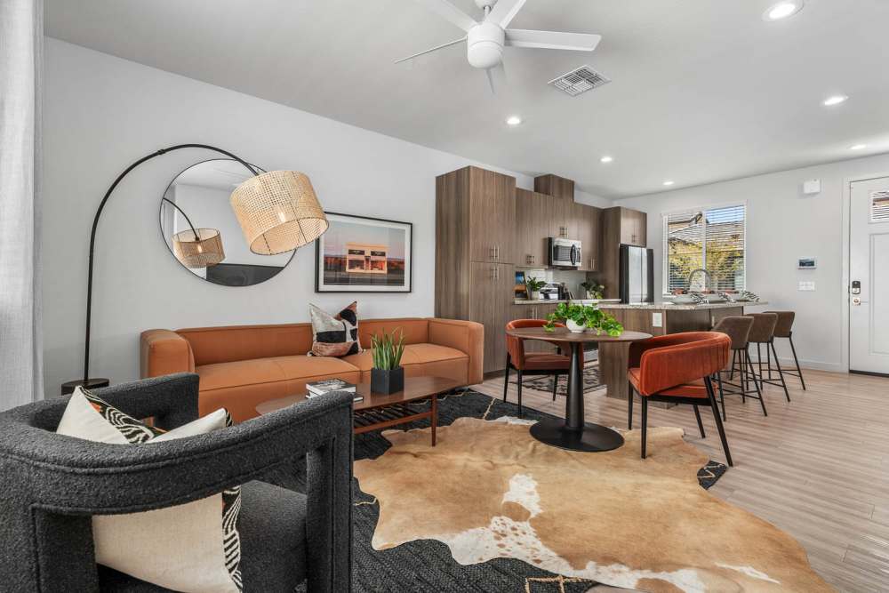 Specious living room with coffee table and view of kitchen at Obsidian at South Mountain in Phoenix, Arizona