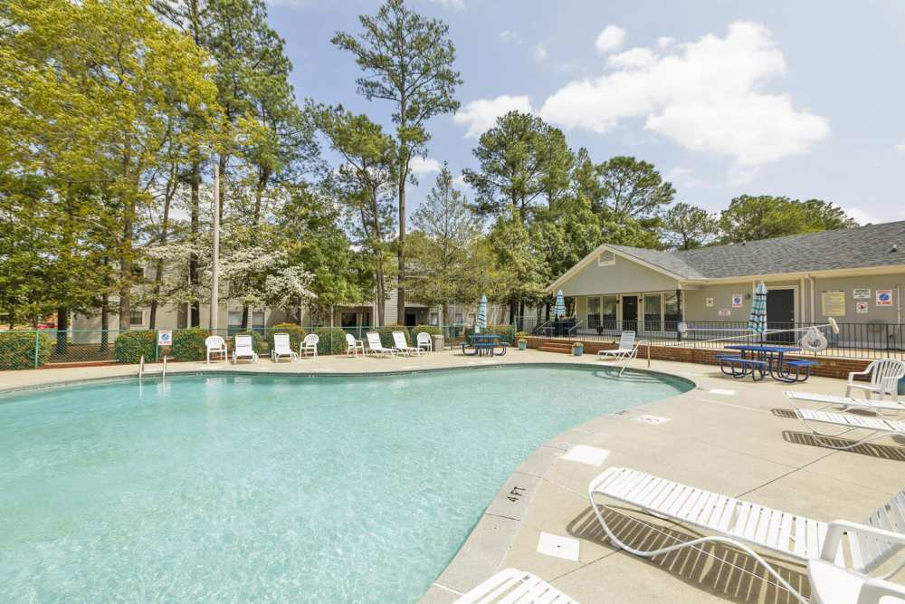 Resort-style swimming pool with lounge chairs at Landmark Flats in Fayetteville, North Carolina