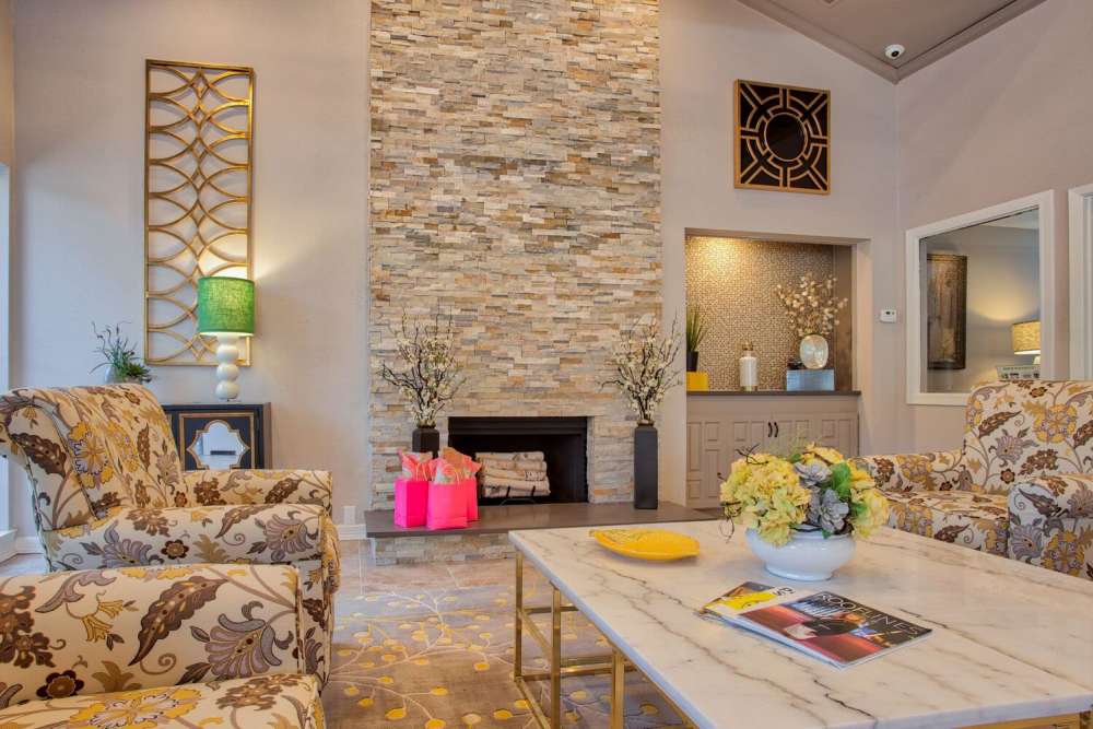 Clubhouse with seating area and fireplace at The Pines of Palos Verdes in Mesquite, Texas