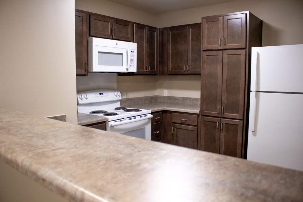 Kitchen with wooden cabinets at Adair Court in Atlanta, Georgia