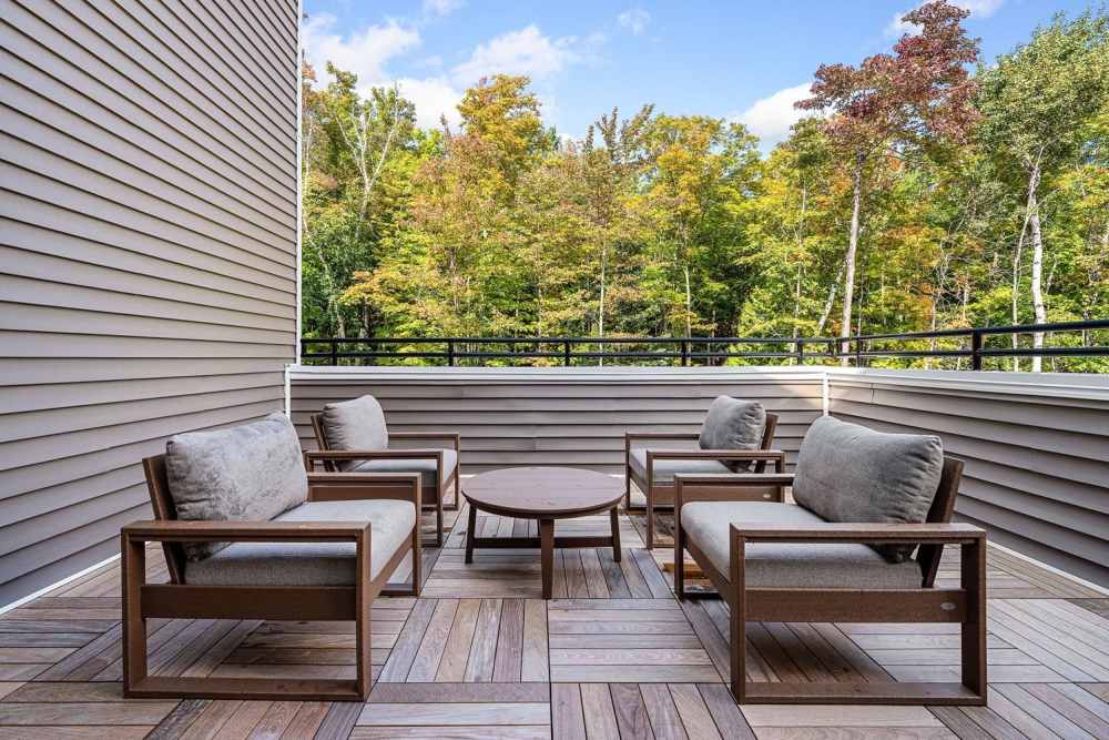 Cozy patio with comfortable seating and a scenic view of colorful trees at Black Rock Crossing in Marquette, Michigan
