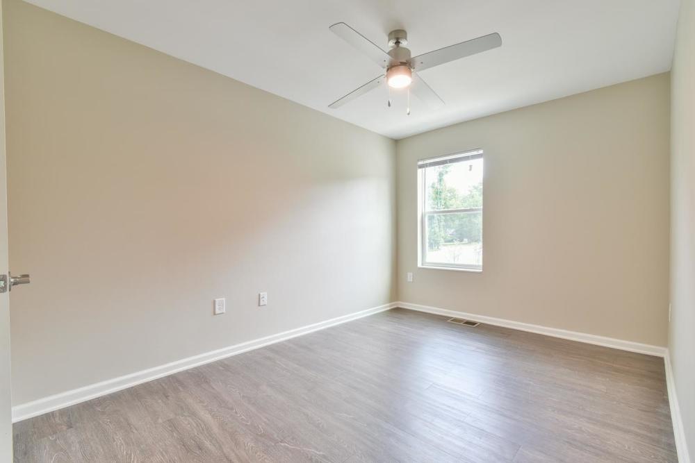 Bedroom with wood flooring at Canaan Crossing in Madison. GA