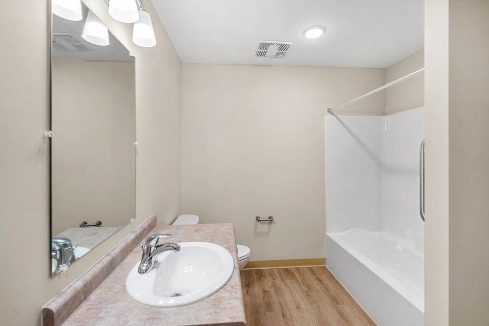 Bathroom with walk-in shower at Deville Manor in Oswego, Illinois