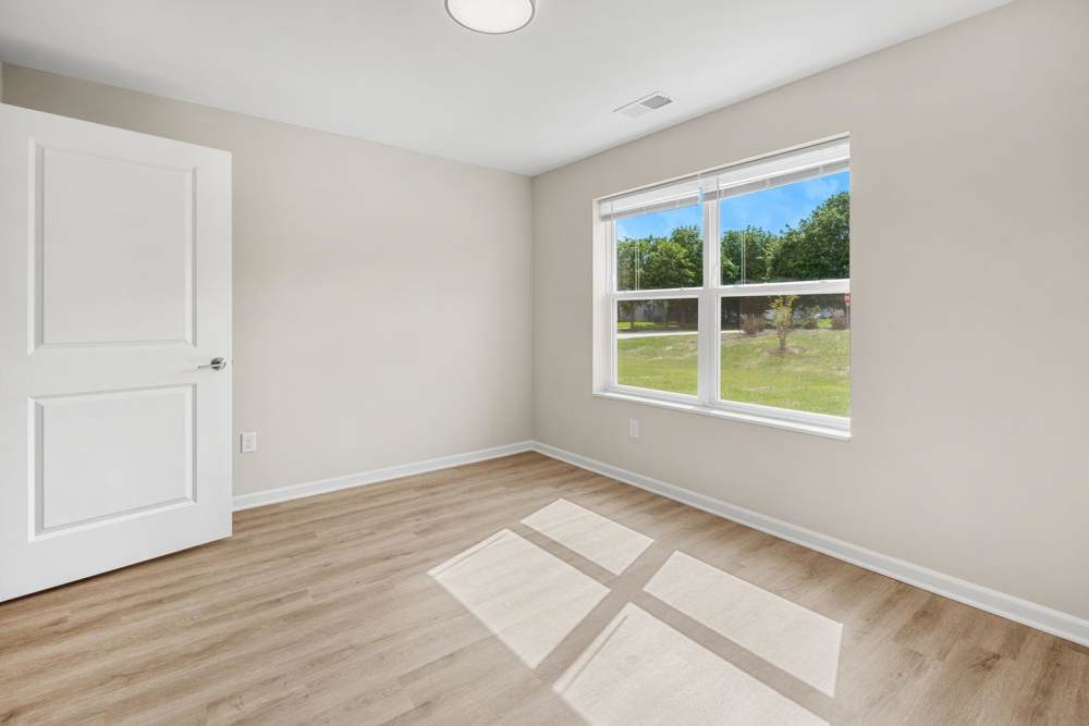 Bedroom with natural lighting at Deville Manor in Oswego, Illinois