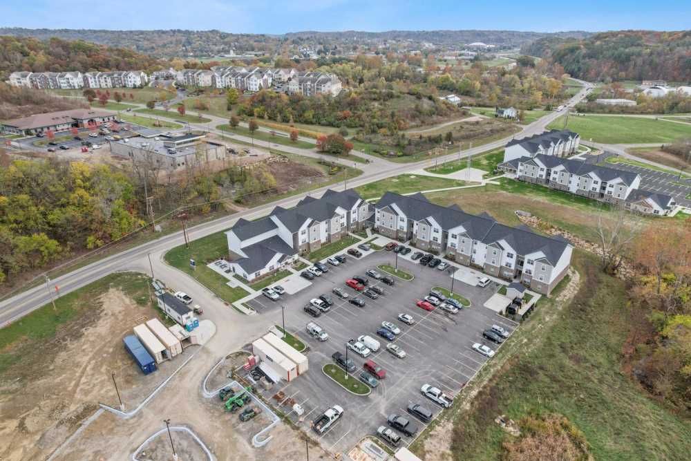 Aerial view of apartment community with ample parking and nearby greenery at Kershaw Greene III in Athens, Ohio
