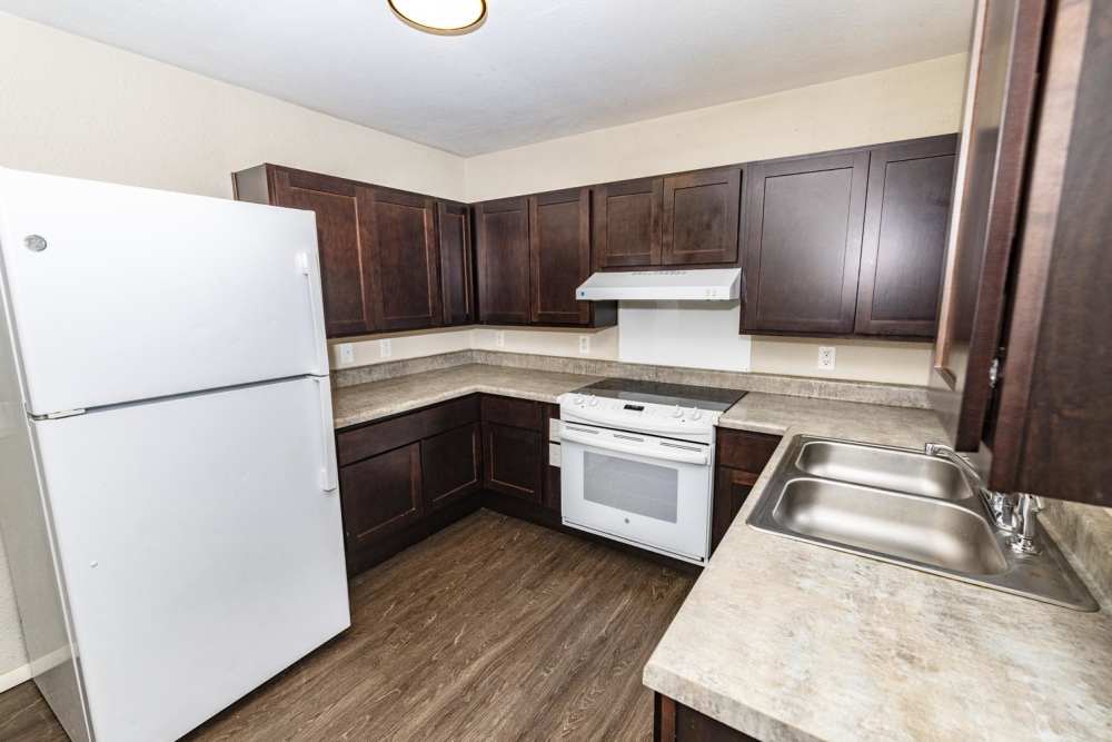 Kitchen with wooden cabinets and stainless-steel appliances at Taylor Crossing in Green Bay, Wisconsin