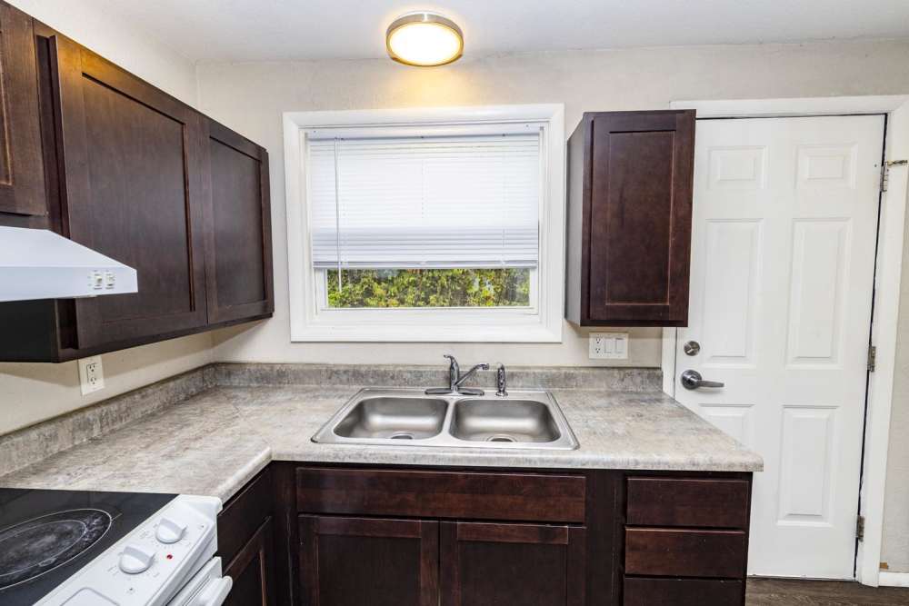 Kitchen with wooden cabinets and stainless-steel appliances at Taylor Crossing in Green Bay, Wisconsin