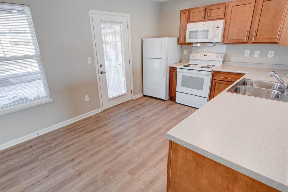 Fully equipped model kitchen with an access to patio at Stanley Terrace in Plainfield, Indiana