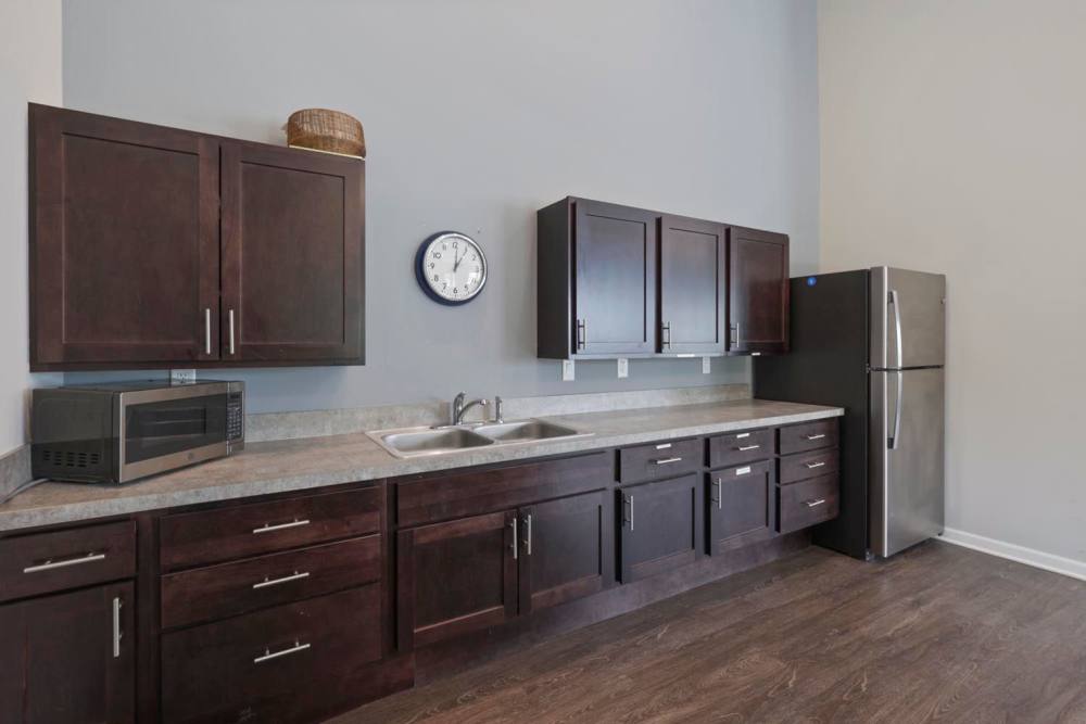 Modern kitchen with dark wood cabinets, stainless steel appliances, and granite countertops at Wheatland Crossing II in Columbus, Ohio