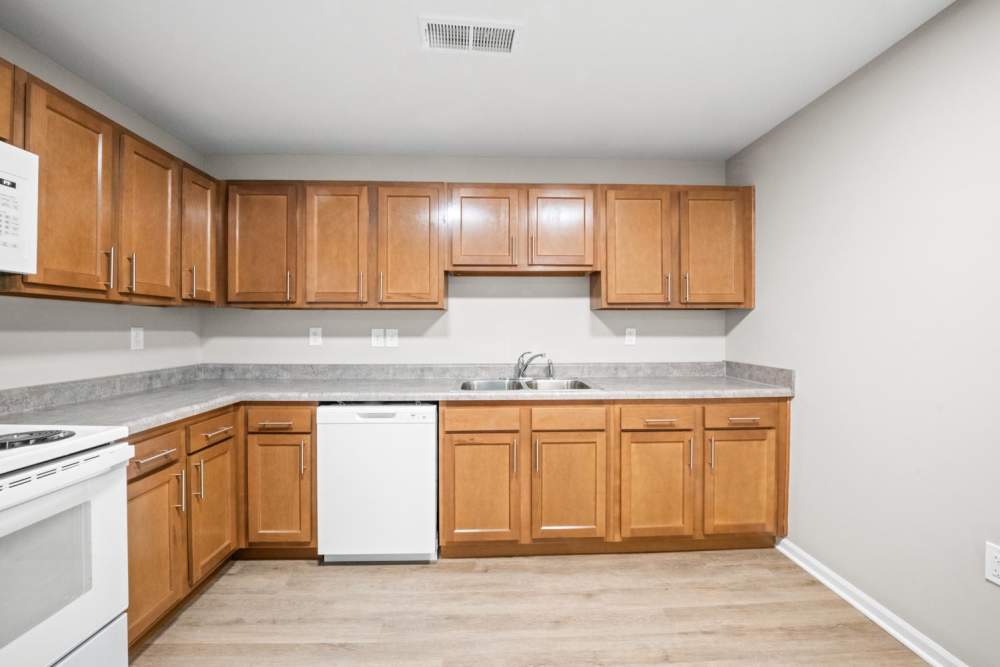 Kitchen with wooden cabinets at Washington Greene in Charleston, West Virginia