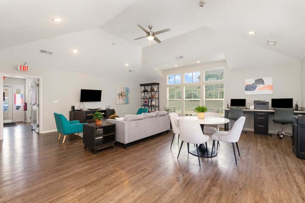 Bright open layout with wood-style flooring, modern furniture, and large windows for natural light at Towne Creek Crossing in Walton, Kentucky