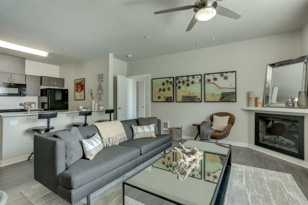 Living Room and Kitchen with Fireplace in an apartment at pet-friendly Terrene at the Grove in Wilsonville, Oregon