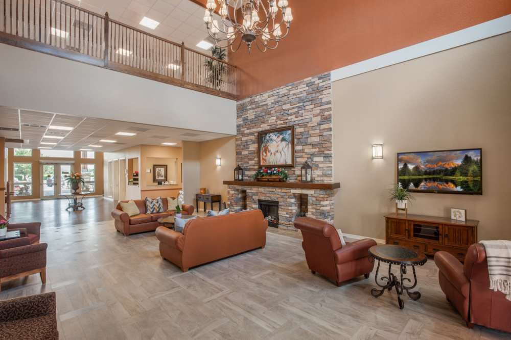 Community clubhouse with seating spaces and fireplace at Grand Villa of Ocala in Ocala, Florida