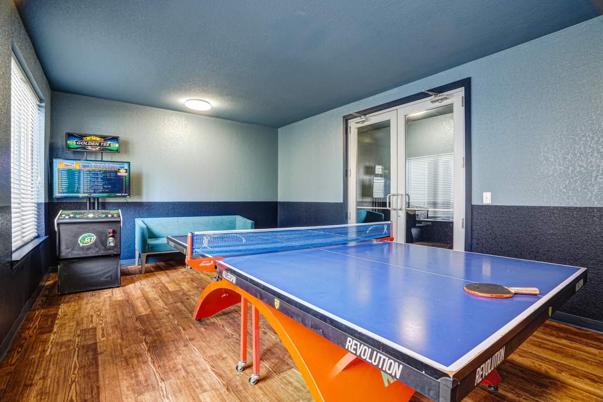 Community game room with wood flooring at The Nine in Louisville. KY