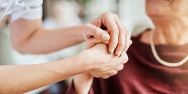 Resident holding hands with their nurse at Geneva Lake Manor in Lake Geneva, Wisconsin