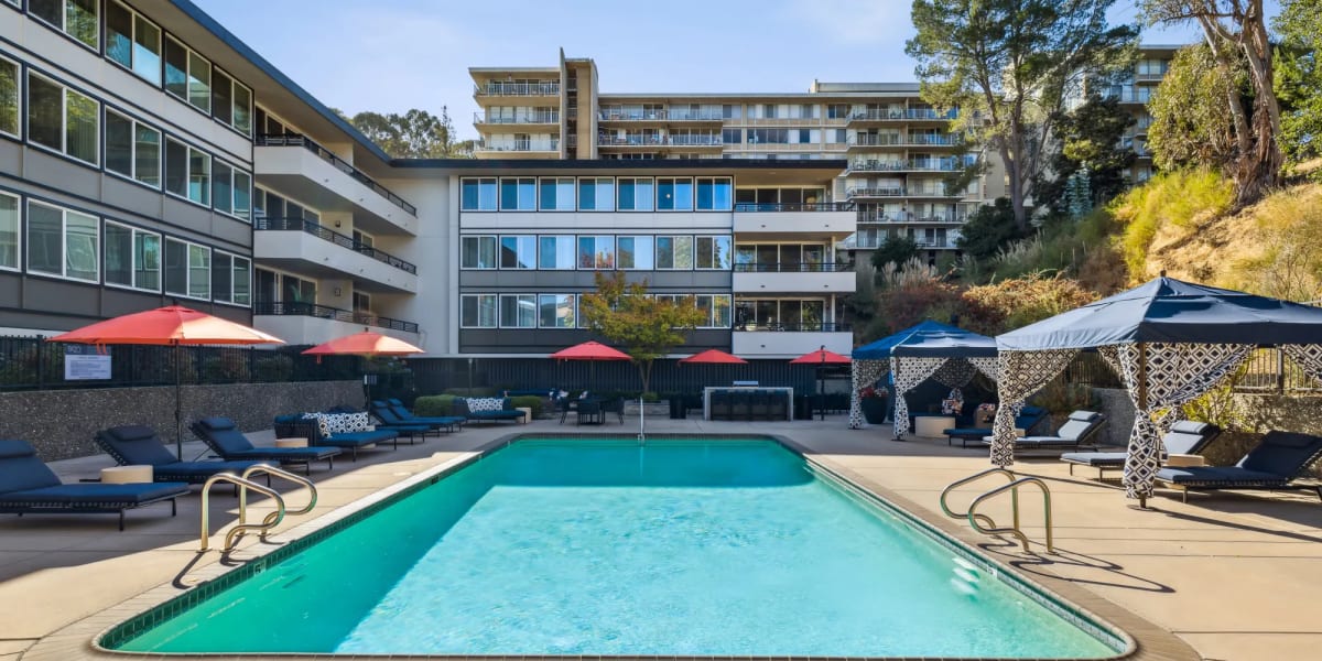 Spacious swimming pool and view of apartments in the background at Belmont Glen Residences in Belmont, California