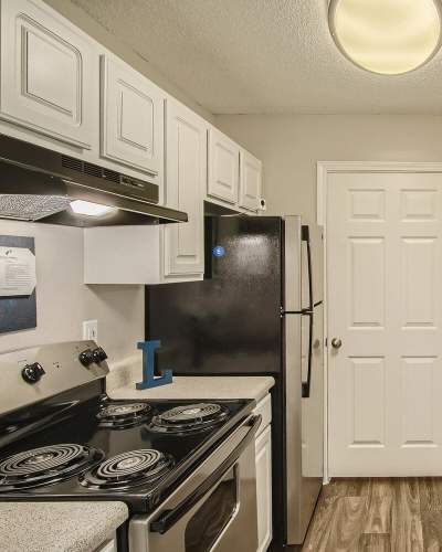 Cozy kitchen with wood-style flooring at Leaf Stone Apartments in Covington, Georgia