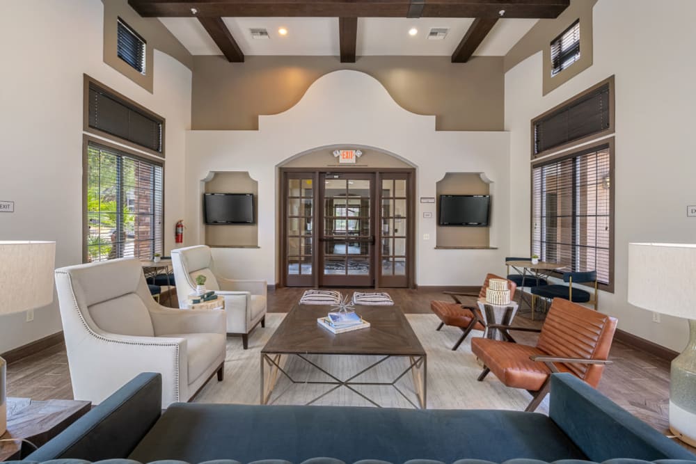 Community clubhouse lounge area with large screen television monitors at Marquis at Sonoran Preserve in Phoenix, Arizona