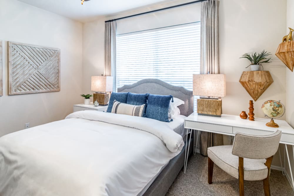 Bright and carpeted bedroom with large window at Marquis of Carmel Valley in Charlotte, North Carolina