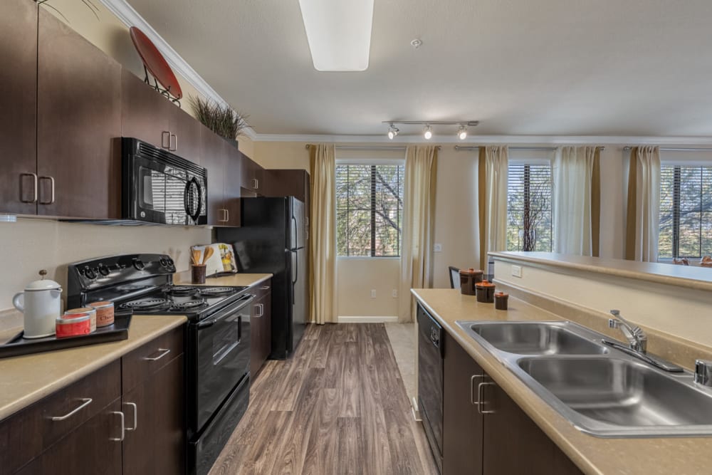 Bright and open kitchen with wood flooring at Marquis at Sonoran Preserve in Phoenix, Arizona