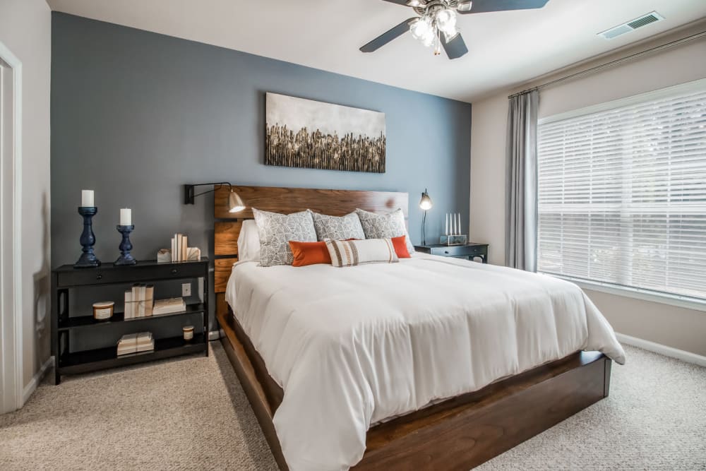 Carpeted bedroom with big window at Marquis at Carmel Commons in Charlotte, North Carolina