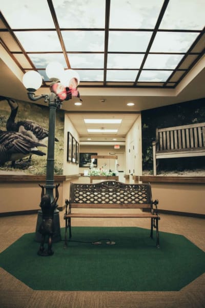 Indoor bench and lamp post on a patch of astroturf at Quail Park Memory Care Residences of West Seattle in Seattle, Washington