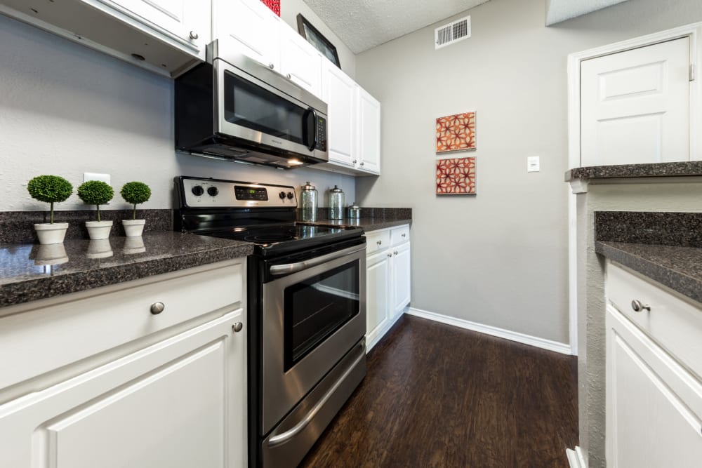 Kitchen with granite counters at Marquis at Legacy in Plano, Texas