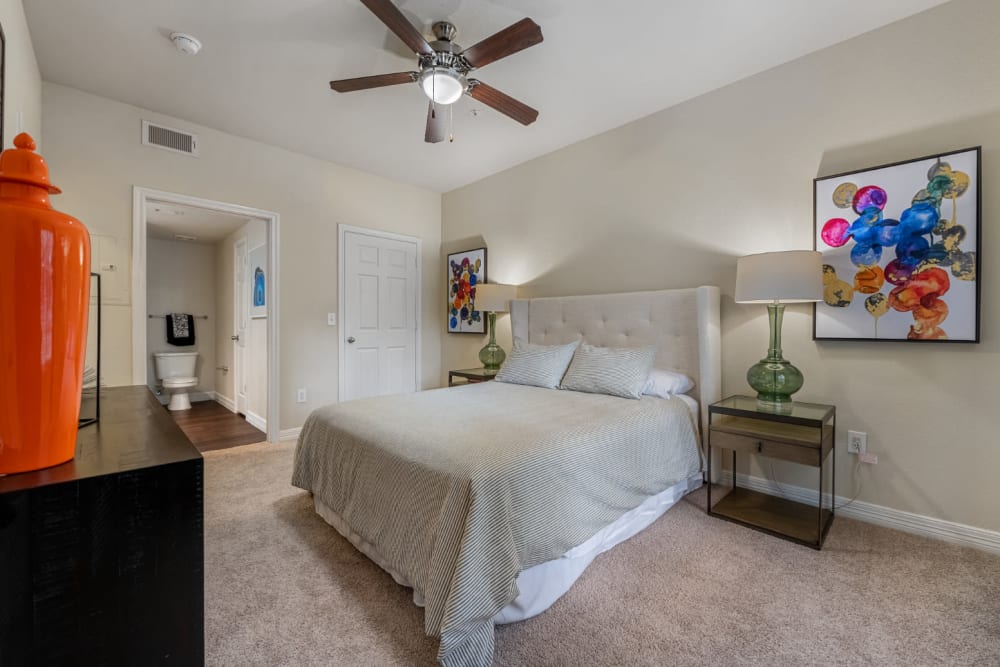 Carpeted spacious bedroom with private bathroom at Marquis at Kingwood in Kingwood, Texas