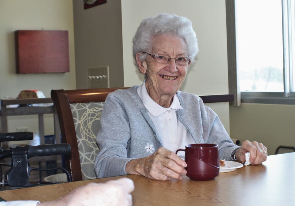 Happy resident having coffee at Edgerton Care Center in Edgerton, Wisconsin