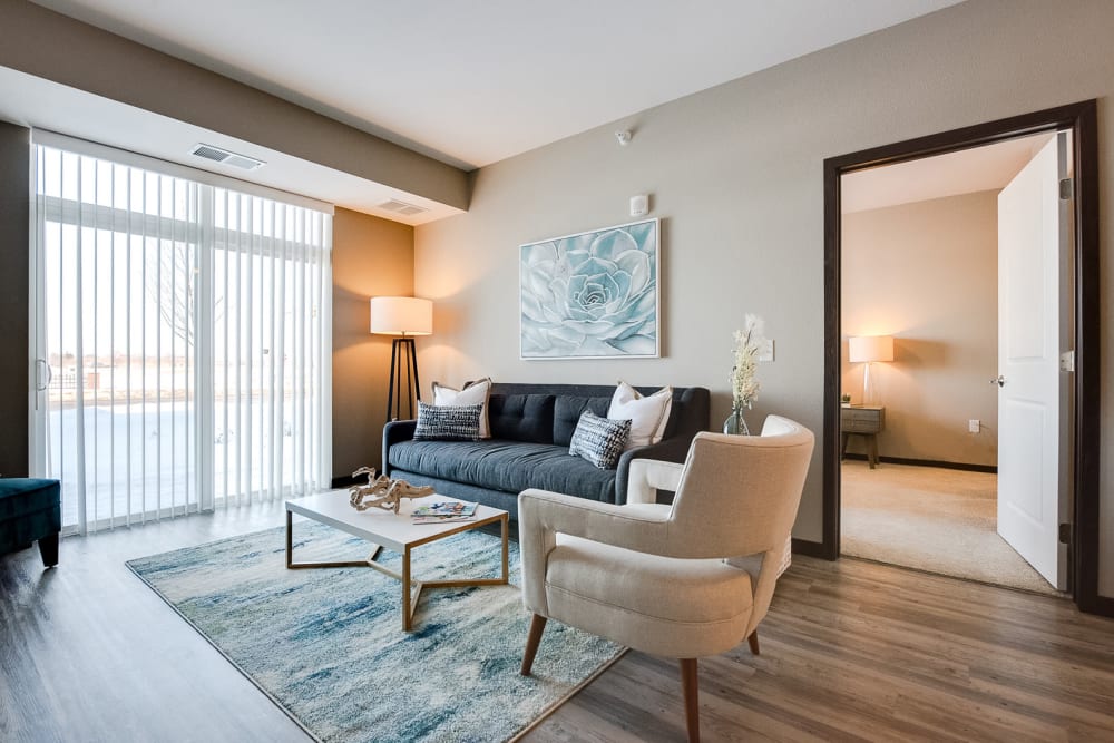 Beautiful, open living room with wood-style flooring at Remington Cove Apartments in Apple Valley, Minnesota